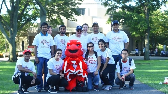 Students posing with Johnny Thunderbird on Great Lawn