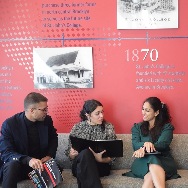 Group of M.B.A. students sitting together, engaging in conversation and networking, each exploring new career paths with the support of their program.